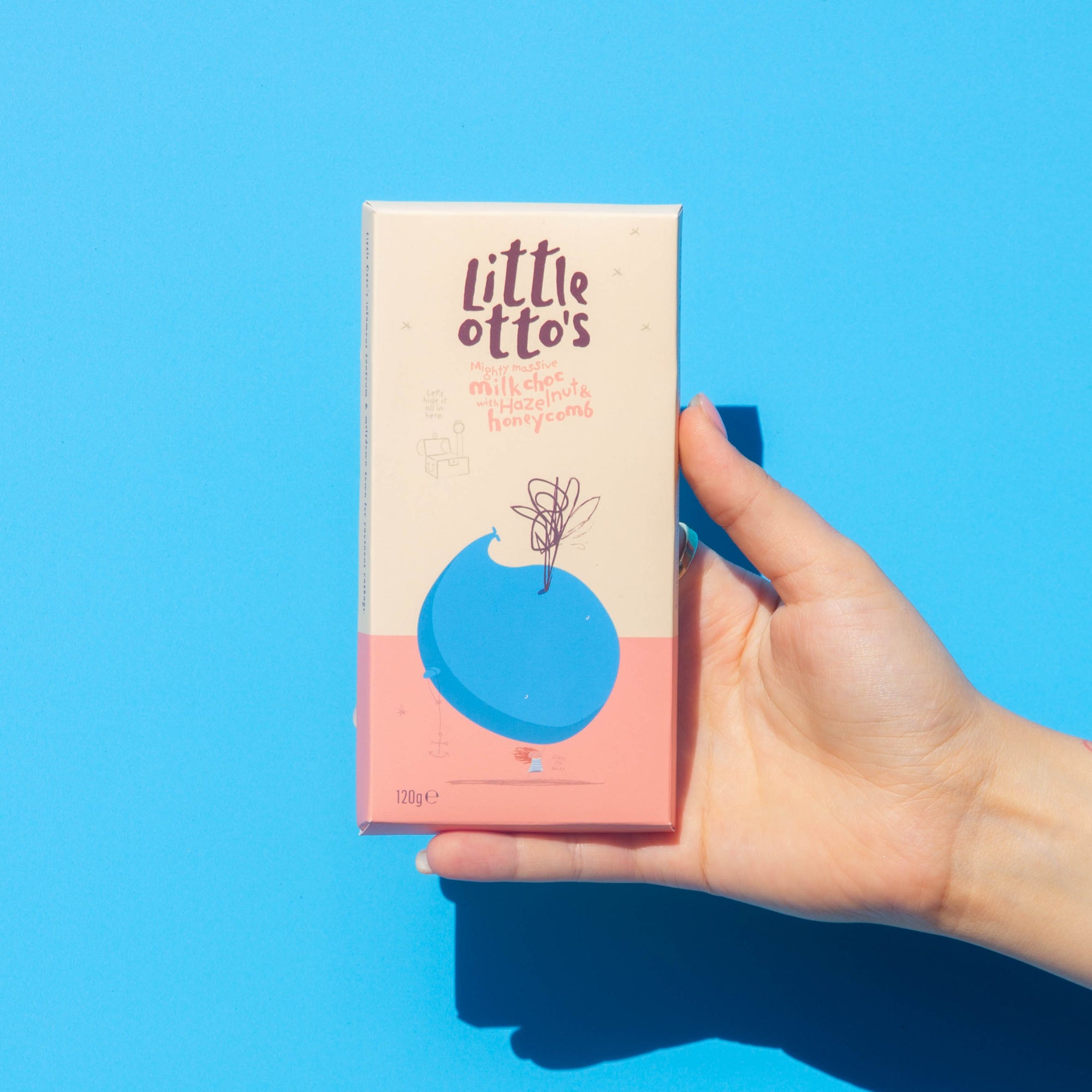 Little Otto's Chocolate bar Milk Chocolate with Hazelnut and Honeycomb nfront of Busselton blue wall