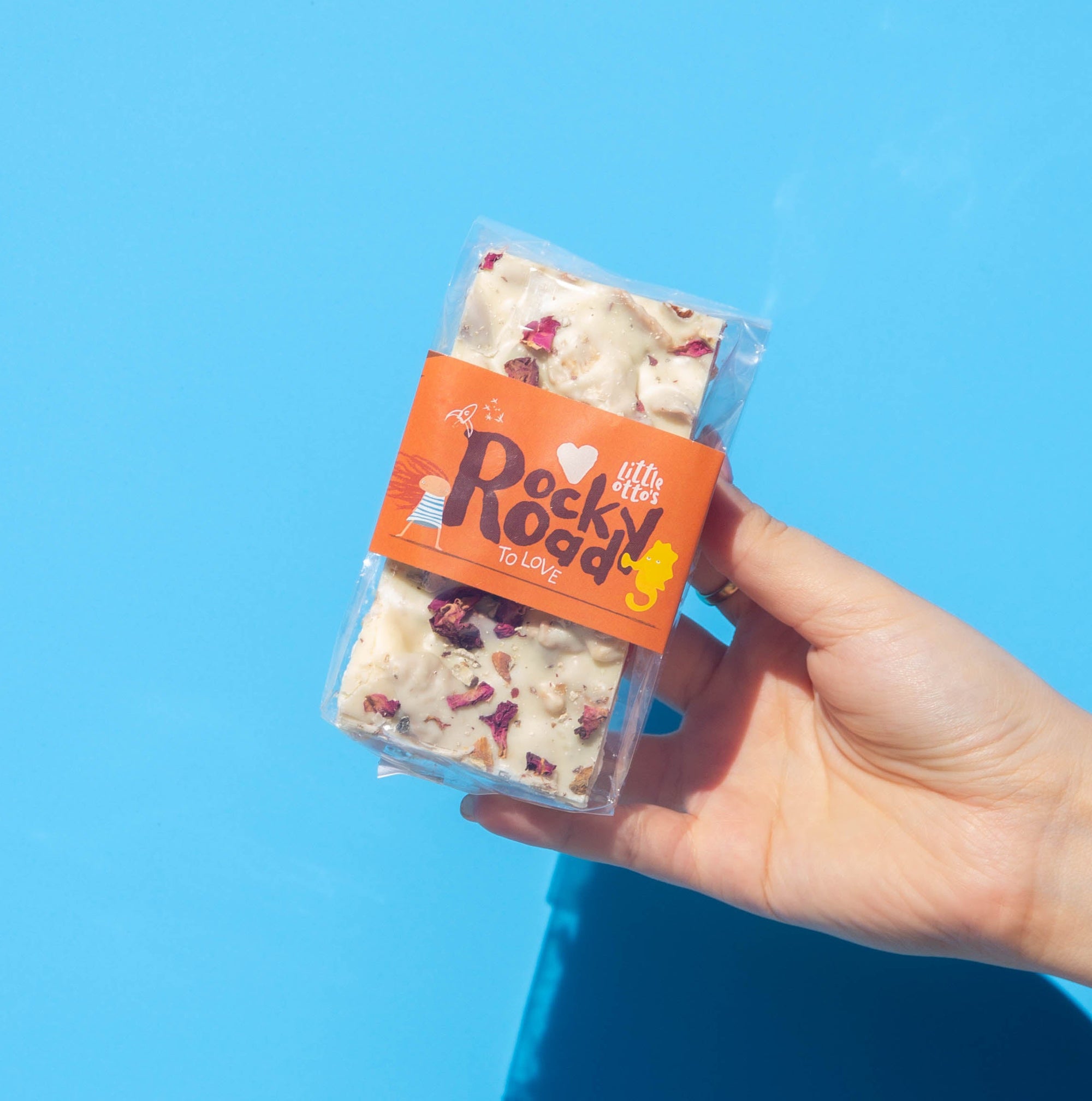 Little Otto's Staff holding Rocky Road to love 240gram infront of Busselton blue wall