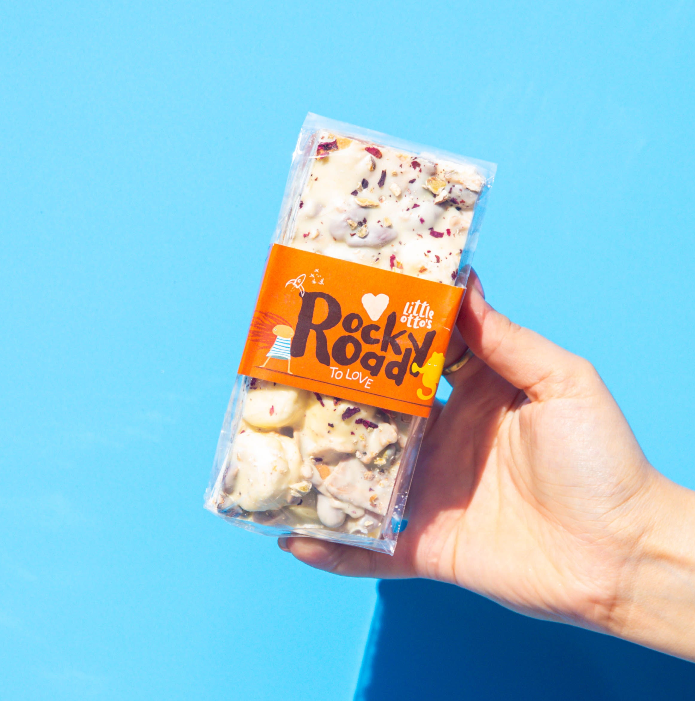 Little Otto's Staff holding rocky road to love 340gram infront of Busselton blue wall