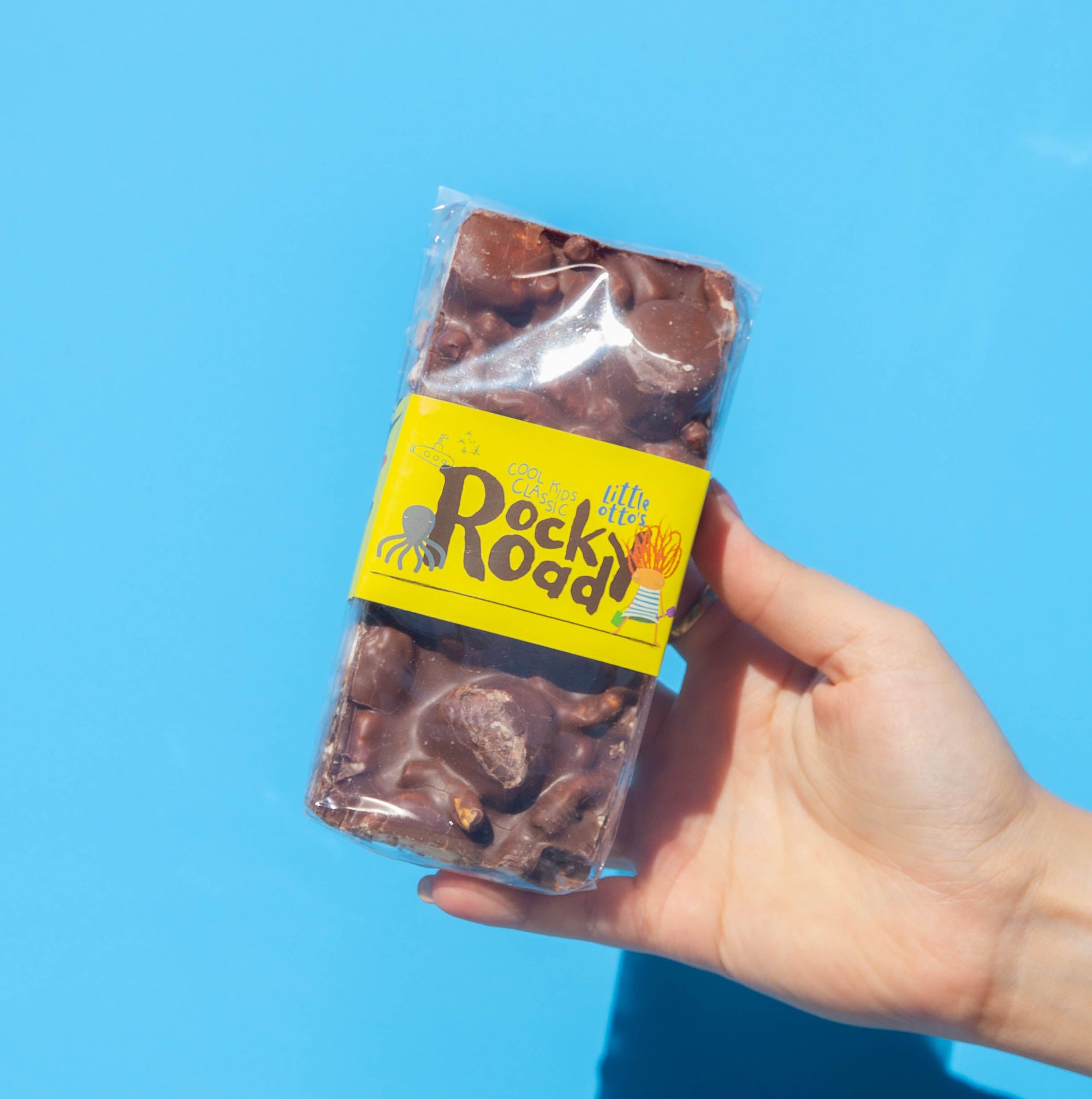 Little Otto's Staff holding cool kids classic infront of Busselton blue wall